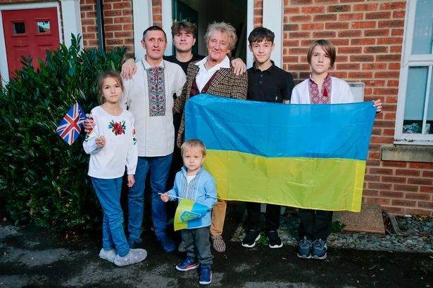 На фото: Род Стюарт з родиною біженців з України