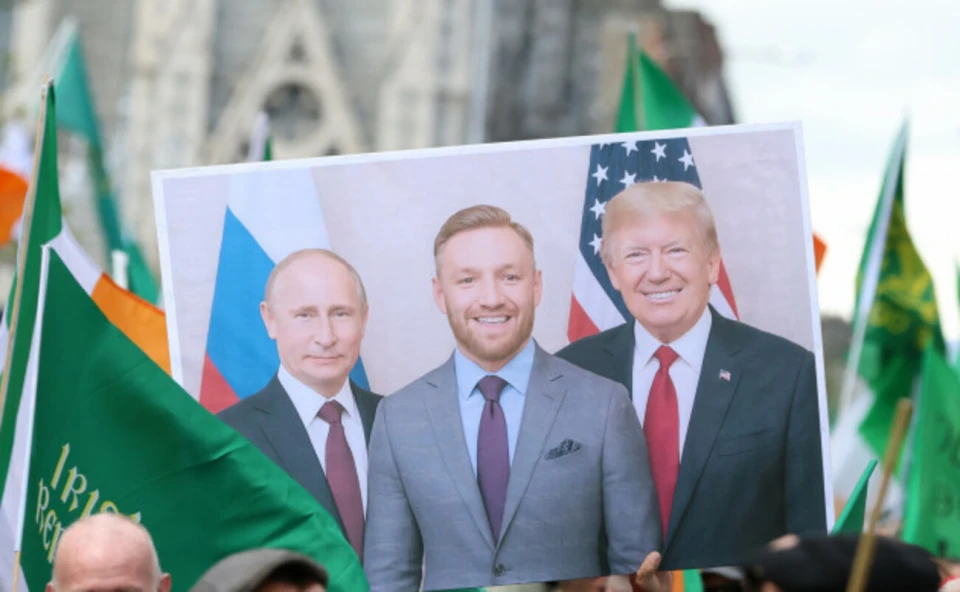 Плакат з портретами Путіна, Мак-Грегора та Трампа в руках одного з учасників